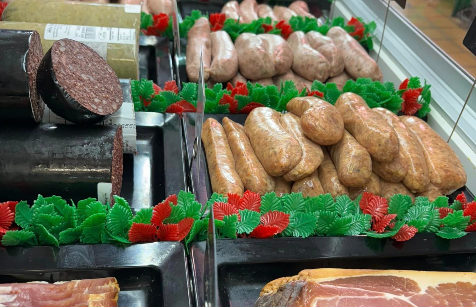 Butchers counter display with different sausages in