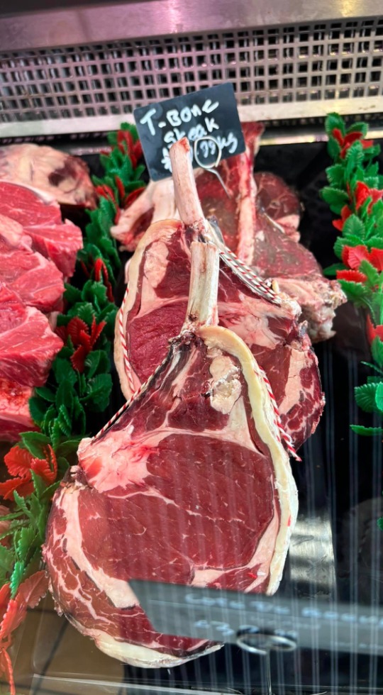 T bone steaks on display in a fridge